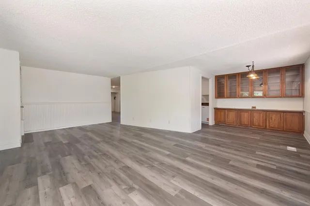 a view of a kitchen with wooden floor and a kitchen