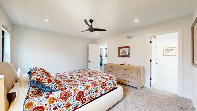 a bedroom with a bed and a dresser in it