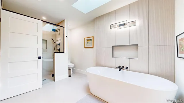 a white bath tub sitting next to a white toilet