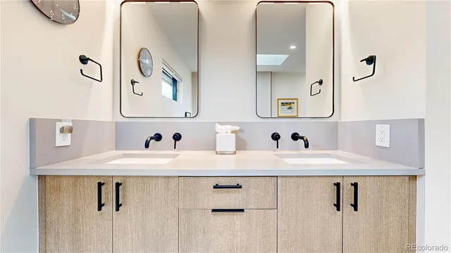a bathroom with a granite countertop sink a mirror and vanity