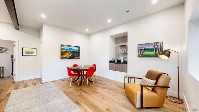 a living room with furniture a rug and a table