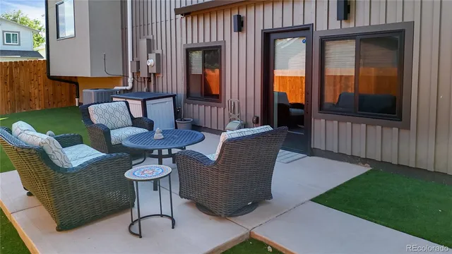 a view of a house with backyard and furniture