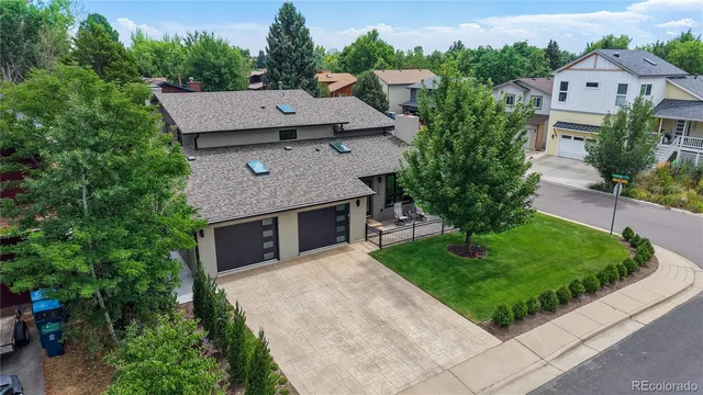 an aerial view of a house with a yard and garage