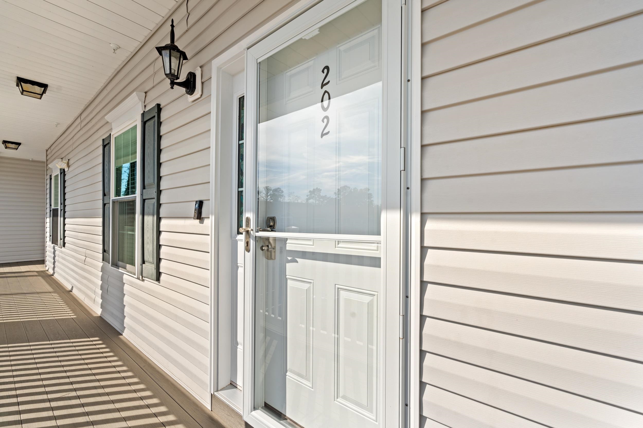 900 Jackline Place, Unit 202 Murrells Inlet, SC 29576 - Photo 16 of 39 View of exterior entry featuring a porch