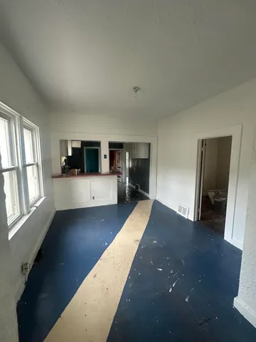 a view of a living room with furniture and wooden floor