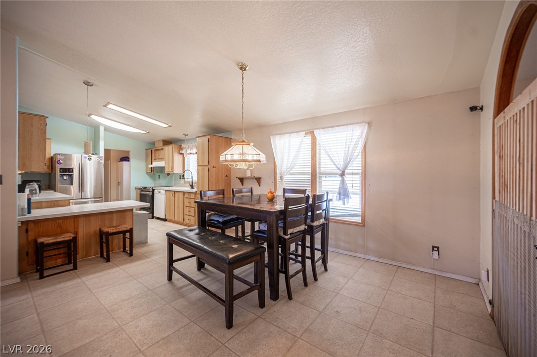 3200 Maple Road Pahrump, NV 89048 - Photo 13 of 53 Functional kitchen and dining area with practical tile flooring and ample cabinet space.