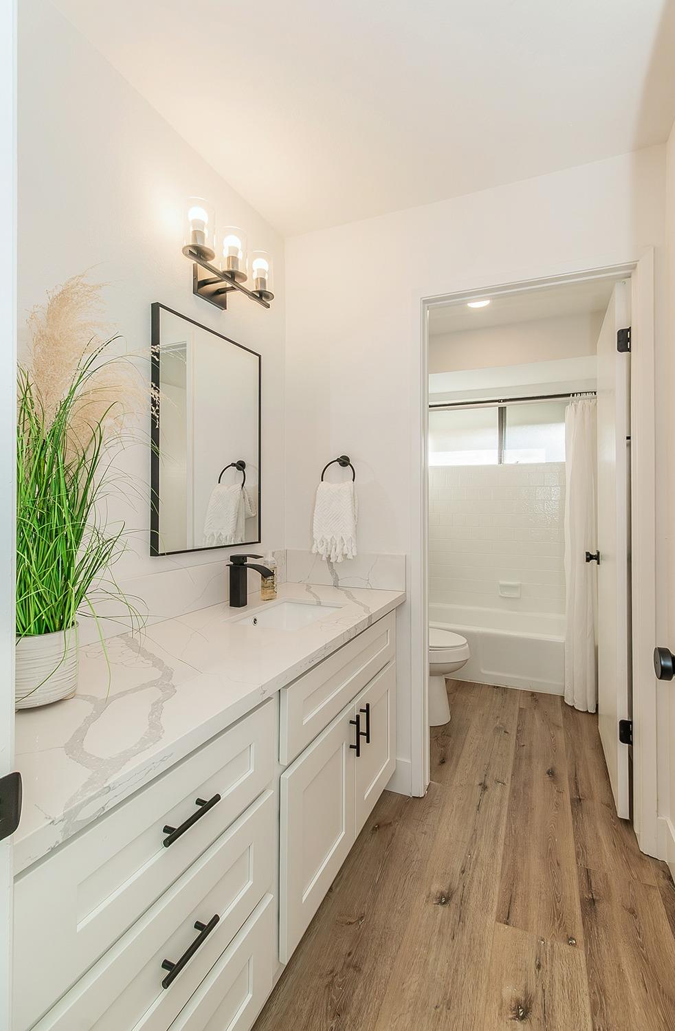 1824 Cougar Lane Clovis, CA 93611 - Photo 23 of 31 a bathroom with a sink a mirror and a shower