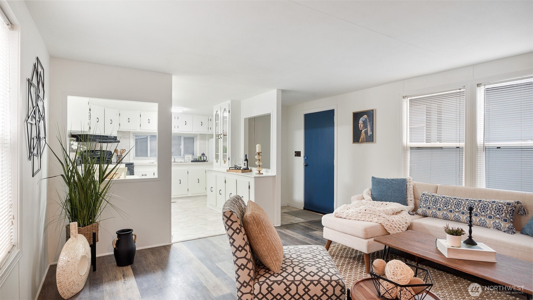 a living room with furniture potted plant and a table