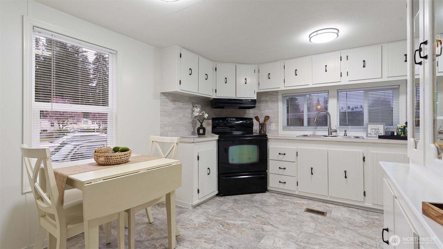 11622 Silver Lake Road, Unit 20B Everett, WA 98208 - Photo 7 of 38 a kitchen with a stove white cabinets and a window