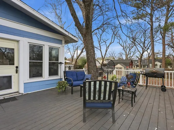 a view of a chairs on deck with wooden floor and fence