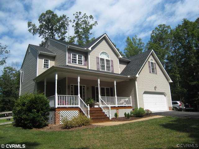 a front view of a house with a yard and porch