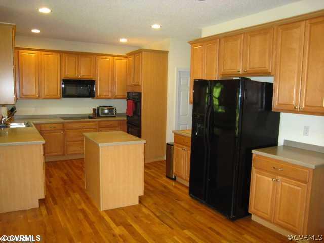 11511 Winterpock Road Chesterfield, VA 23838 - Photo 5 of 12 a kitchen with a refrigerator and cabinets