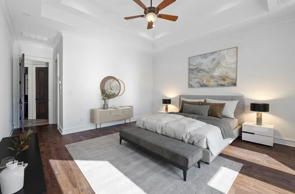 a bedroom with a bed couches and a mirror on the dresser