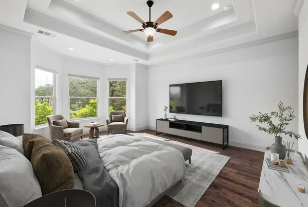 a bedroom with a bed and a flat screen tv