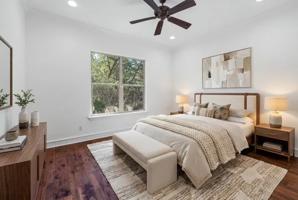 a bedroom with a large bed and a window
