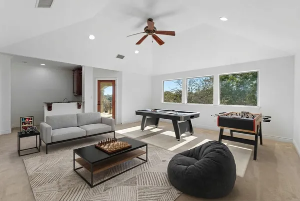 a living room with furniture a rug and a large window
