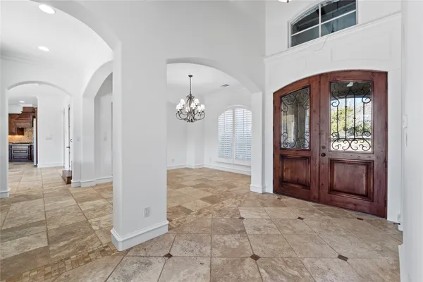 a view of an entryway door and a hallway
