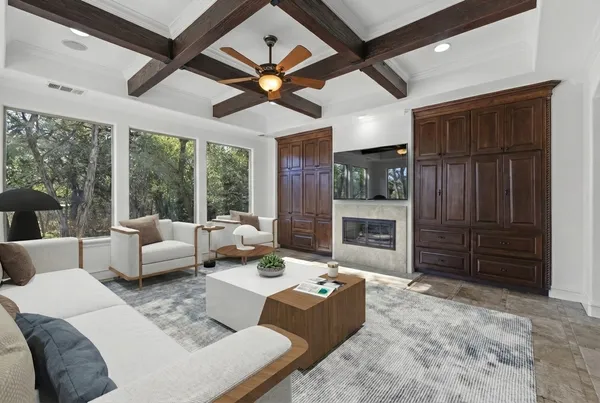 a living room with furniture a ceiling fan and a window