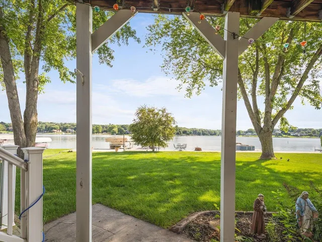 a view of a house with garden and a tree