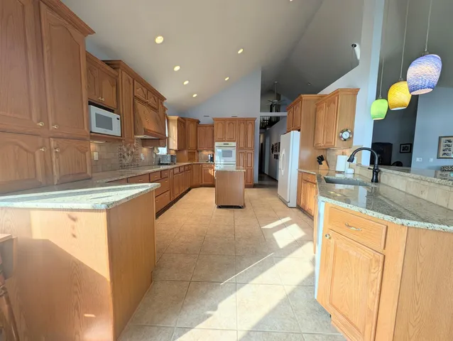 a view of a swimming pool with a patio and a yard