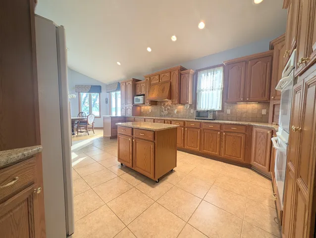 an aerial view of a house with outdoor space and lake view