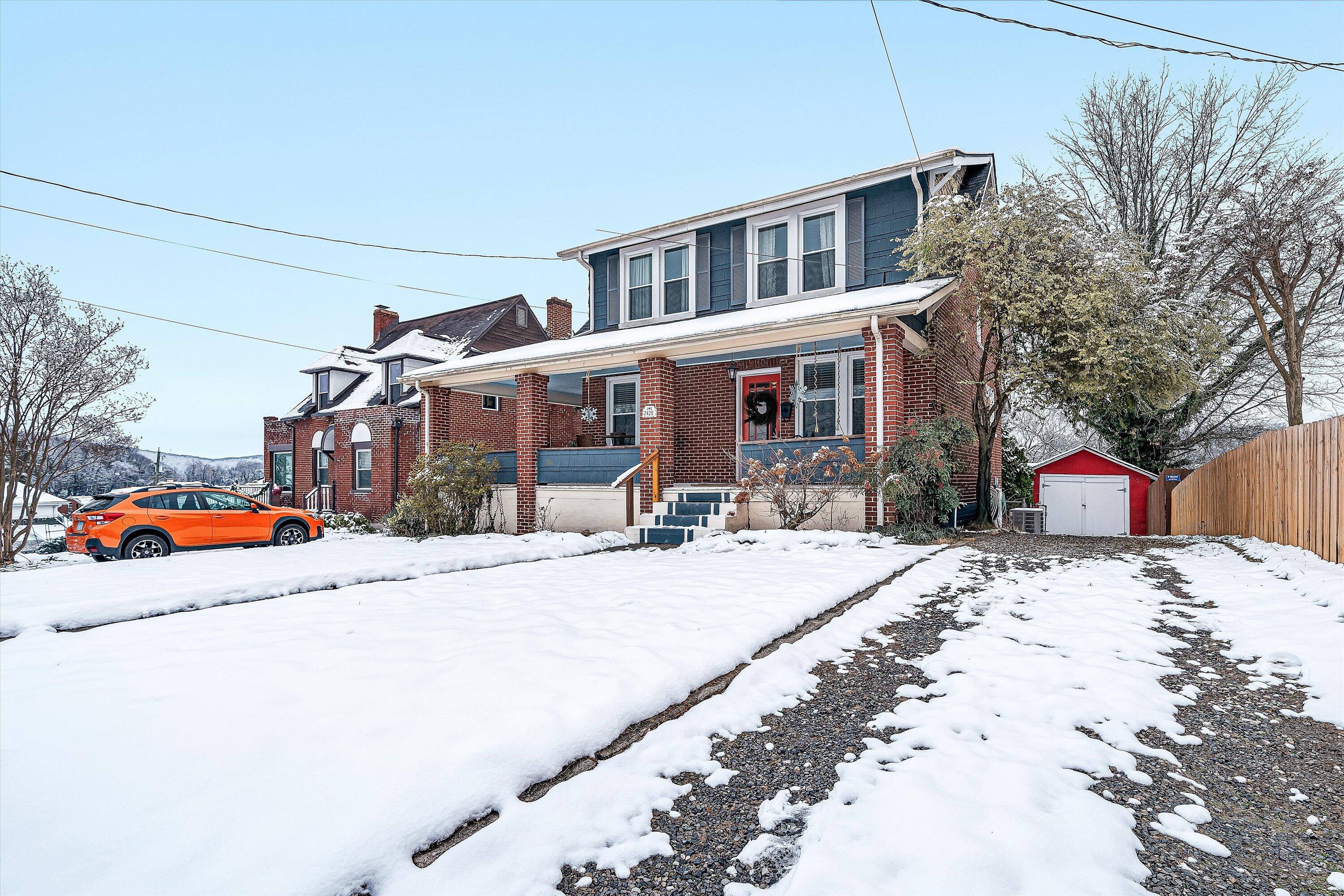 a view of a house with snow on the road