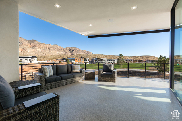 3558 South Cypress Road Hurricane, UT 84737 - Photo 16 of 57 Exterior space featuring a mountain view, a balcony, and an outdoor hangout area