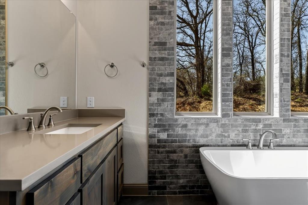 131 Spring Valley Road Paradise, TX 76073 - Photo 24 of 40 a bathroom with a bathtub and a sink