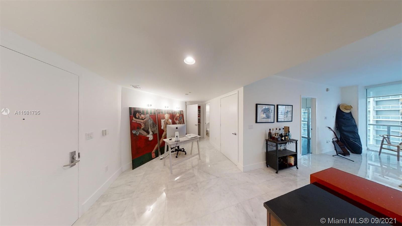 475 Brickell Avenue, Unit 1909 Miami, FL 33131 - Photo 4 of 12 a view of a livingroom with furniture and a flat screen tv
