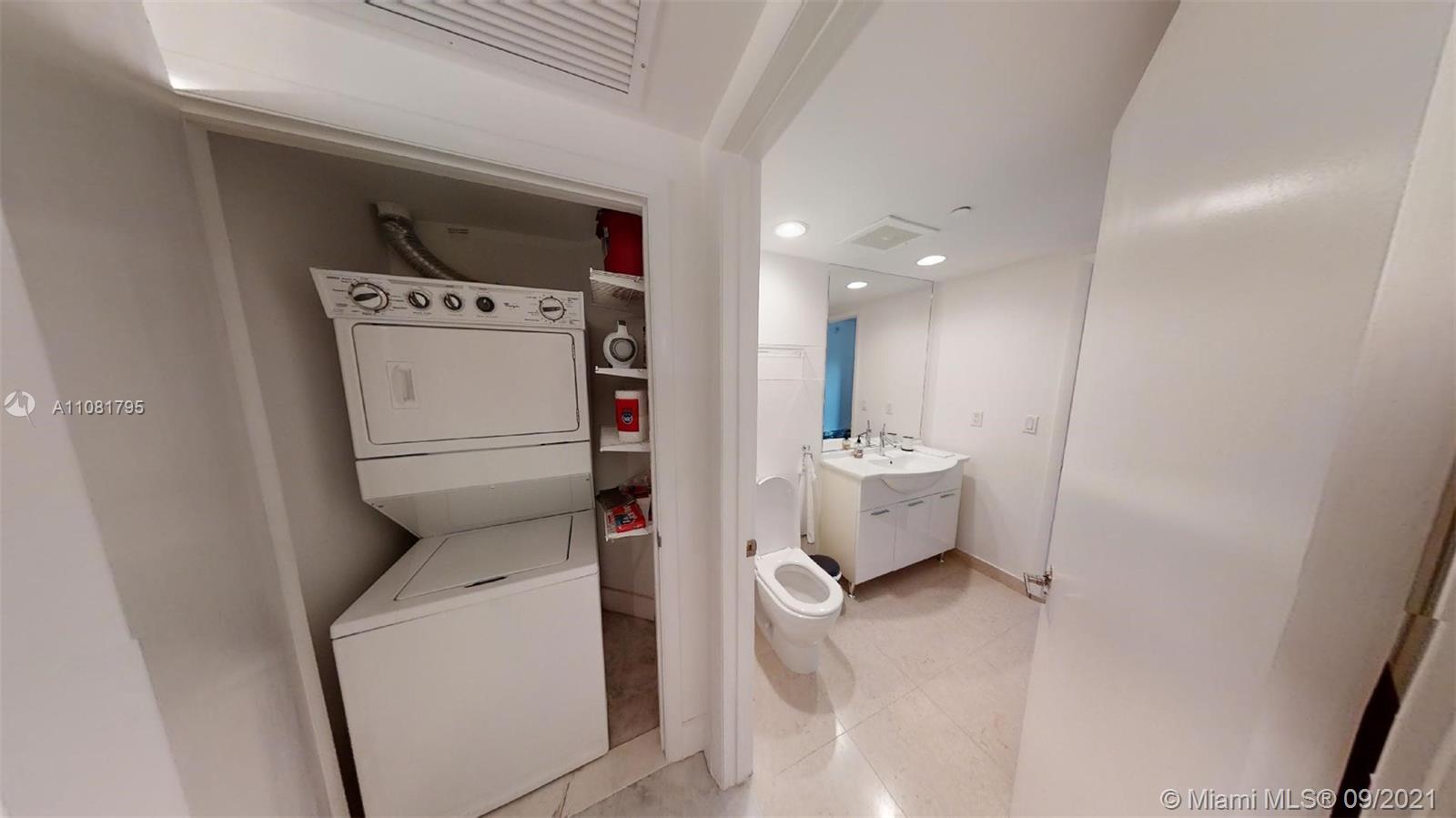 475 Brickell Avenue, Unit 1909 Miami, FL 33131 - Photo 5 of 12 a room with a washer and dryer