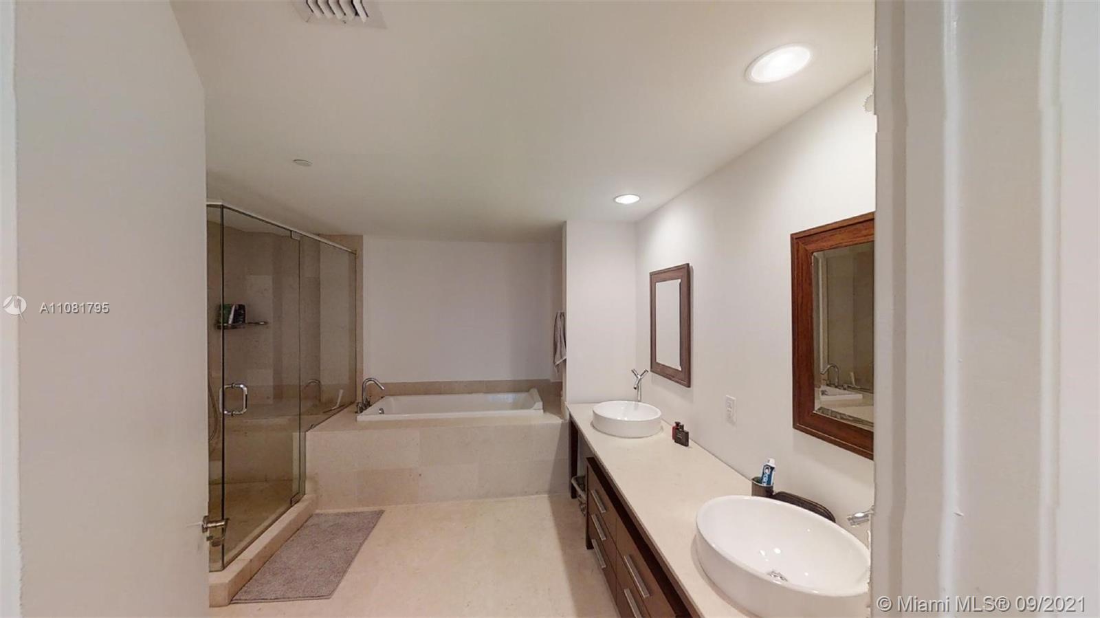 475 Brickell Avenue, Unit 1909 Miami, FL 33131 - Photo 7 of 12 a bathroom with a granite countertop sink a toilet and shower