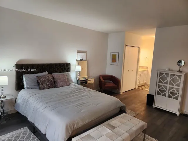 a bedroom with a large bed and a couch