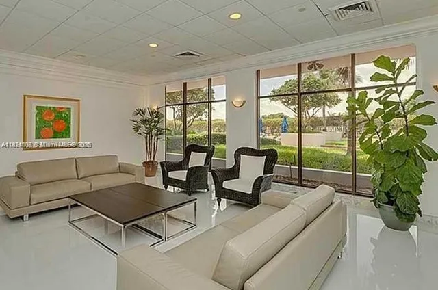 a living room with furniture city view and a large window