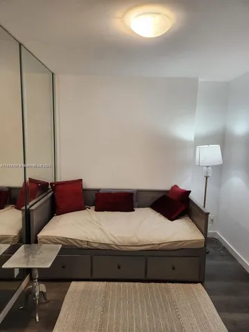 a bedroom with a bed and lamp