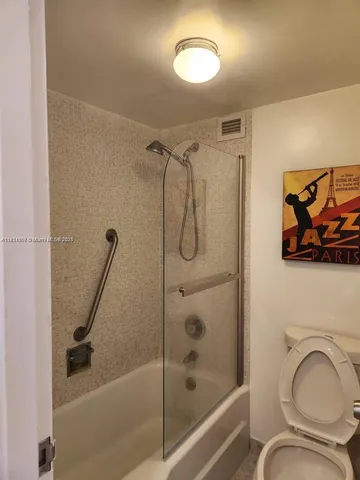 a bathroom with a shower a mirror and a bathtub