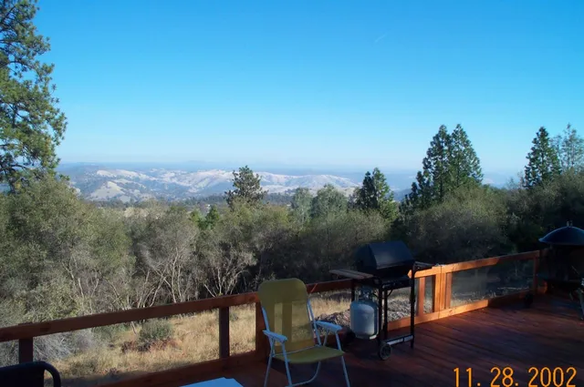 a view of a two chairs in the balcony