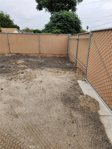 a view of a white house next to a road