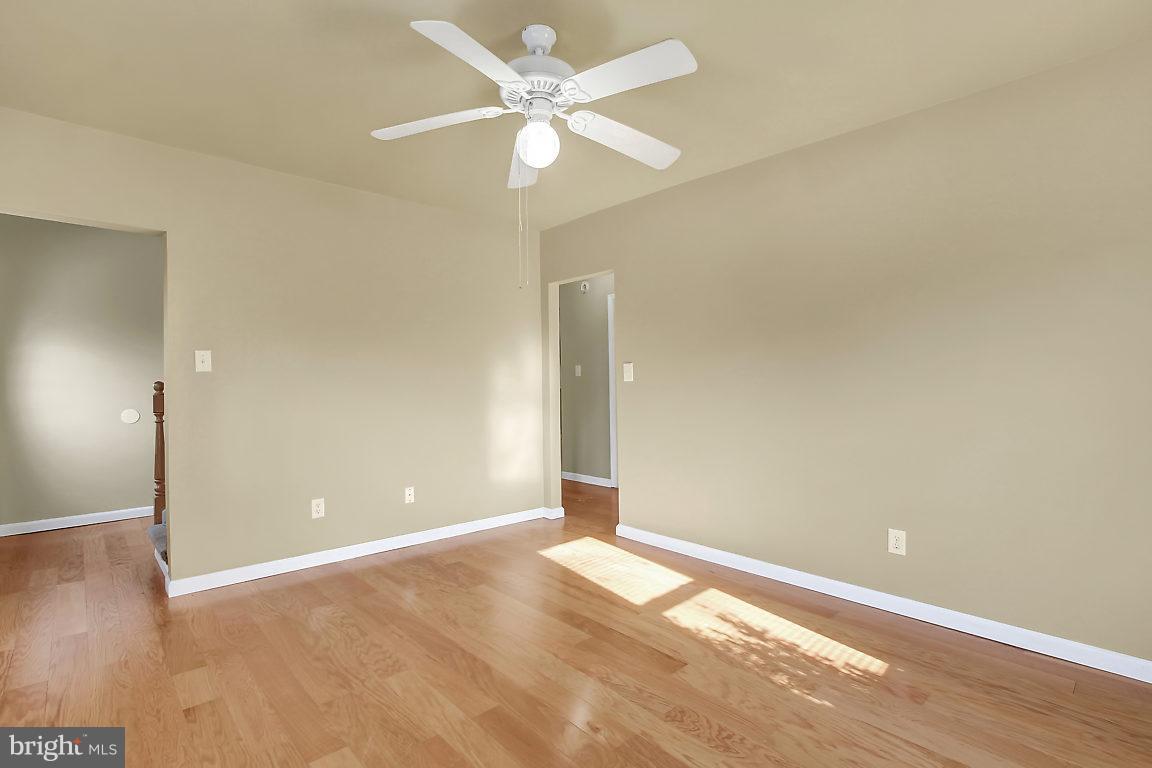 333 Back River Neck Road Baltimore, MD 21221 - Photo 9 of 25 an empty room with fan and a ceiling fan
