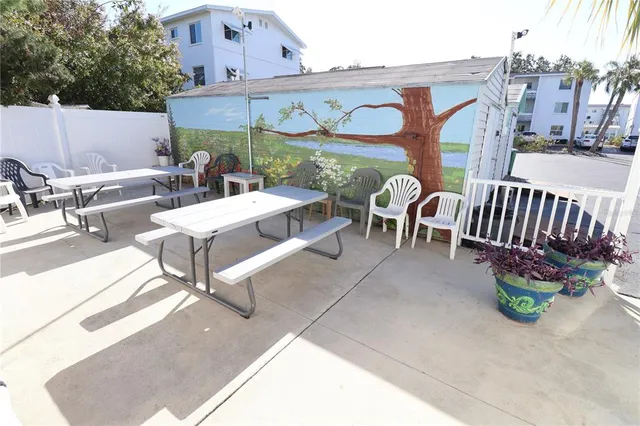 a view of a patio with a table and chairs