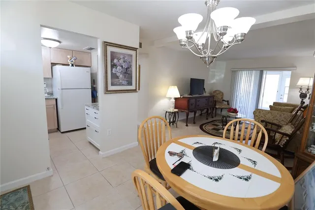 a view of a dining room with furniture and a chandelier