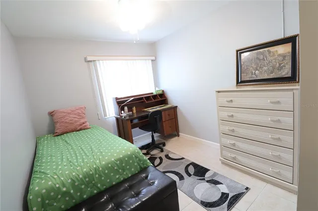 a bedroom with a bed and a dresser