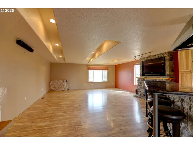 a view of a livingroom with furniture and a flat screen tv