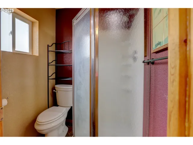 a bathroom with a toilet and a shower