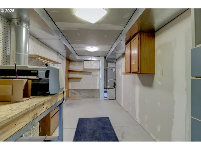 a kitchen with stainless steel appliances kitchen island a refrigerator sink and cabinets