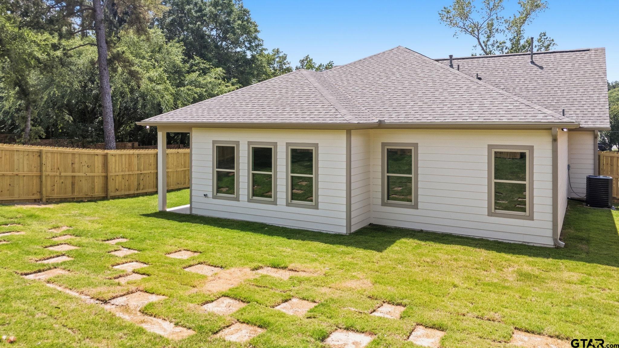 2968 Calloway Road Tyler, TX 75701 - Photo 20 of 24 a view of a house with a backyard
