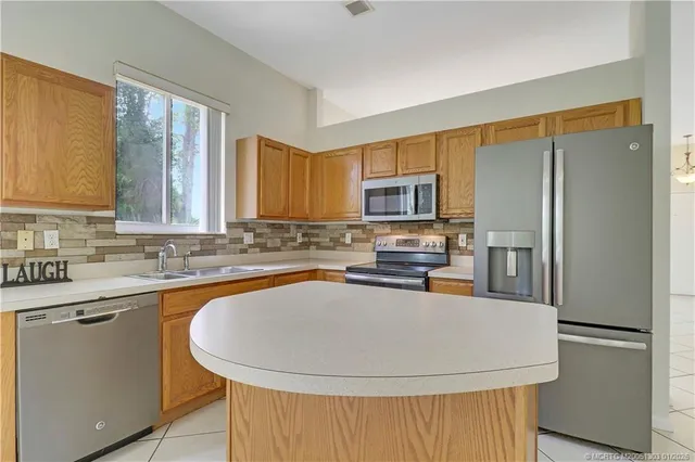 a view of a kitchen with microwave and cabinets