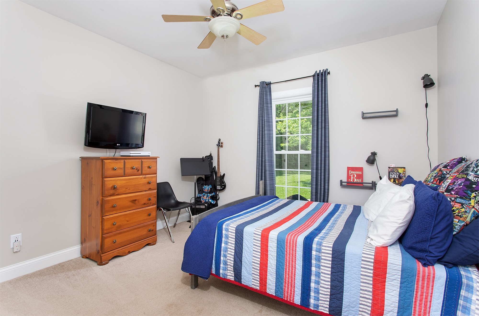 182 West Harper Road Portland, TN 37148 - Photo 18 of 29 a bedroom with a bed and a flat tv screen on dresser