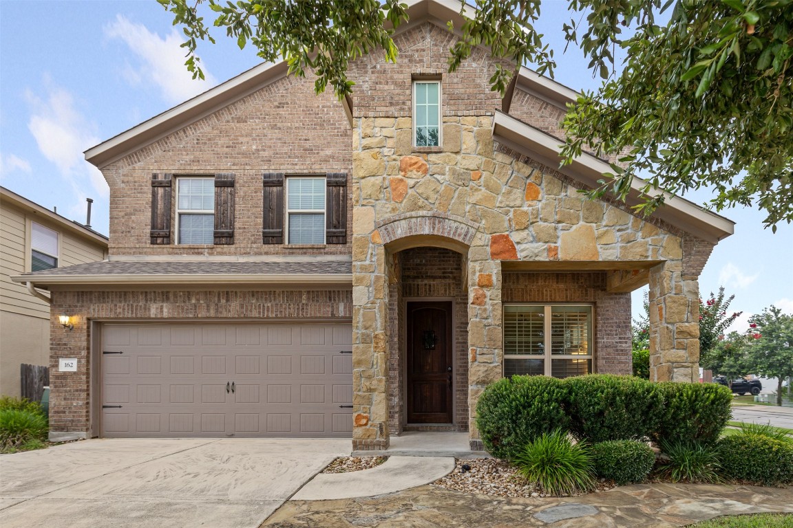 a front view of a house with garden