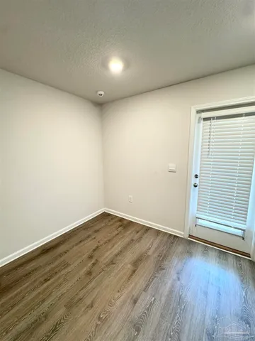 a view of wooden floor and brick walls
