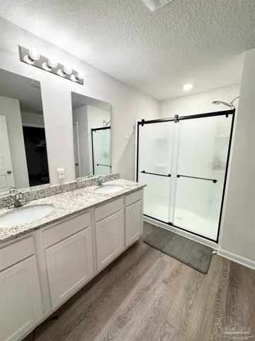 a bathroom with a double vanity sink and mirror